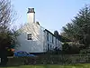 A long roughcast house in two storeys