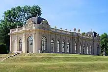 Orangery, steps and four cherub statues on pedestals