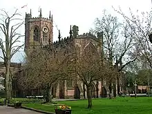 A stone Gothic church with an octagonal tower