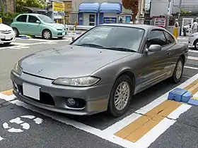 Front-three-quarter view of a two-door car with door mirrors