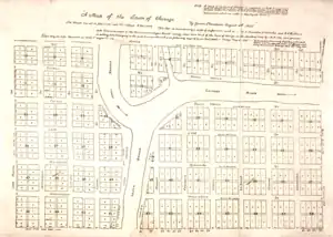 A survey of a 58-block town, trisected into roughly equal parts by the river.