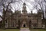 Thoresby Hall and adjoining outbuildings, gate and railings