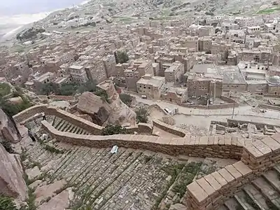 Look from above at fortification steps and a city below