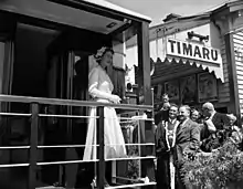 Queen Elizabeth II of the United Kingdom delivers a whistle-stop speech during an appearance in Timaru during her 1954 royal visit to New Zealand (of which she was the reigning monarch)