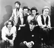 Promotional picture for Contents Dislodged During Shipment, 1979Left to right: Chris Butler, Harvey Gold, Michael Aylward, Ralph Carney, Mark Price, Stuart Austin