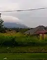 The Titiwangsa Mountains near Rembau, looking south. Mount Tampin is recognizable as the light grey triangular mountain rising behind Mount Datuk (with the cloudy peak).