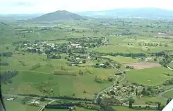 Tokanui Hospital in the centre left, Tokanui Settlement in the foreground and Mount Kakepuku in the background