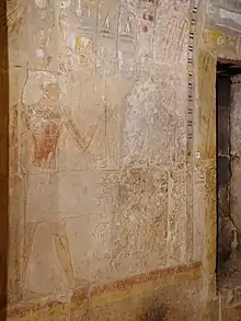 Relief art depicting two subjects, one of whom has been near totally erased