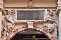 On the western portal of the Henri IV courtyard of the Toulouse Capitole, two sculpted figures embody Lady Tholose / Pallas (1678).