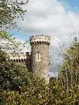 Garden wall with gateways and Folly Tower attached to west and east of Caerhays Castle