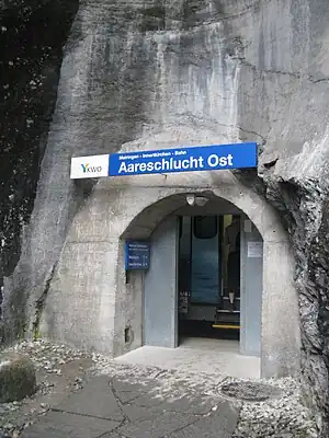 Rock face with entrance and sign above