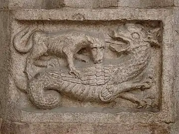 A wyvern fighting with a wolf, relief, Trento Cathedral, Italy