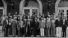 Photograph of the Marine Biological Laboratory trustees standing in front of a building