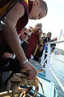 Tibetan monk releases a crab into the ocean