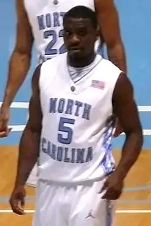 A basketball player wearing a jersey that reads "North Carolina".