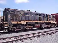 The 1811 was built for the U.S. Army by EMD.  It is an EMD MRS-1 class locomotive that has adjustable gauge trucks to run in Europe and Russia. Now it belongs to the museum at Fort Eustis, but sits abandoned in Hanks Yard.