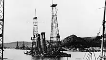 Photograph showing both ships partially underwater, the cage mast stick out of the water