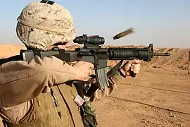 USMC-spec M16A4 fitted with ACOG, vertical foregrip, and AN/PVQ-31.