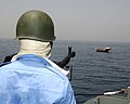 The Pakistan Navy's Master-at-Arms observes the VBBS drill holding on the naval gun in Gulf of Oman in 2005.