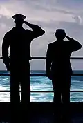 YNSN Jessica Gardner and YNSN Whitney Utter salute as USS Kitty Hawk (CV-63) passes over final resting spot of USS Lexington (CV-2).