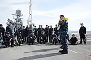 YN2 Thomas Jones demonstrates life preserver inflation during "abandon ship" drill aboard USS Makin Island (LHD-8).