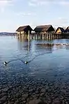 Pile dwelling over a lake.