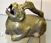 Urinal in the form of a tiger. Stoneware with olive green (celadon) glaze. Southern Dynasties, 500-589 CE. From China, Zhejiang. Victoria and Albert Museum