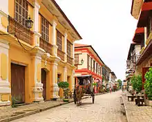 Street of three-storied ramshackle colonial style buildings.