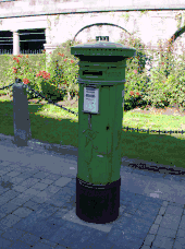 VR pillar box in Kilkenny, Ireland, painted green with obvious door repair