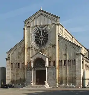 Church of San Zeno, Verona, Italy, The façade is neatly divided vertically and horizontally. The central wheel window and small porch with columns resting on crouching lions is typical of Italy.