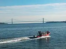 United States Coast Guard on patrol in Upper New York Bay. The Verrazzano-Narrows Bridge across the Narrows is visible in the background.