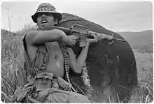 A  U.S. soldier in Vietnam wearing various amulets, including the "peace symbol" and the Buddhist swastika (1971 photograph).