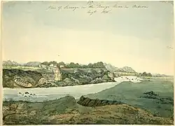 Watercolour of a river and a fort. The river's flow is disturbed by some small rocks; a hidden creek or stream runs into the river in the foreground; a small boat has been pulled out of the water and left resting on the far bank. The fort, with six visible turrets, is built on the edge of a cliff overlooking the river. Hills line the distant background.