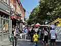 People walking past stalls on St Peter’s Street at St Albans Market.