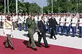 Vladimir Putin accompanied by Castro and the unit commander, inspecting members of the honour guard outside the office of the Council of State, December 2000.