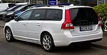 Rear drivers side view of white V70 with gloss black trim