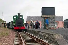 The Slieve Callan locomotive stopped at a station on the West Clare Railway.