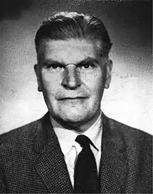 1950s image of Walter Hincks, a middle aged man in a suit.