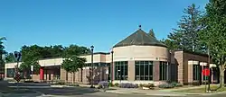 A one-story, at-grade building with a corner rotunda