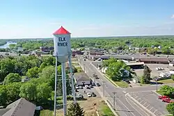 Aerial view of a metal water tower with a small cylindrical tank