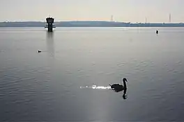 A vast lake with a water tower out of the water