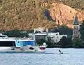 A river cruiser passing Notre Dame de l'Isle (South Vienne)