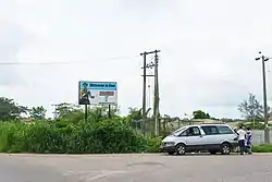 A "Welcome to Owo" signpost