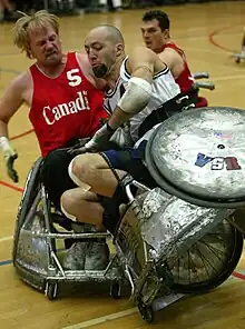 Wheelchair rugby players use wheelchairs with strong frames, foot protection and wheel covers, to prevent injury in this contact sport.