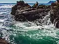 A whirlpool between the large rocks characteristic for the coast line