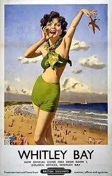 a woman in a green bathing suit trimphantly holds up a star fish and calls out