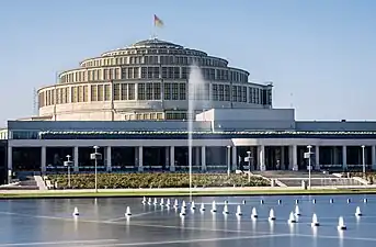 Wrocław Multimedia Fountain in daytime, with historic Centennial Hall beyond