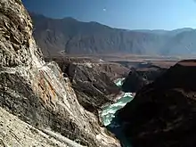 River running through a gorge in a desert mountain landscape.