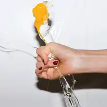 A woman's hand crushing an egg