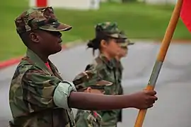 Young Marine PFC Kyle Bryant, an active young Marine, stands at parade rest before a promotion and awards ceremony for active young Marines at the Camp Foster Young Marines building.